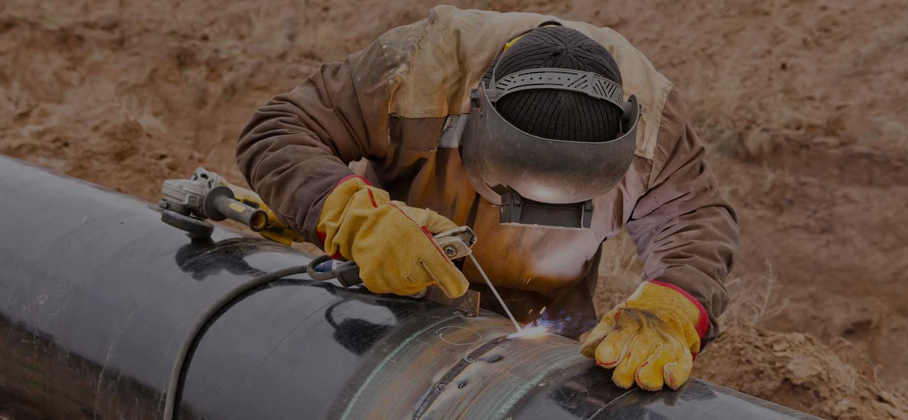 Professional welder performing welding on oil and gas pipelines